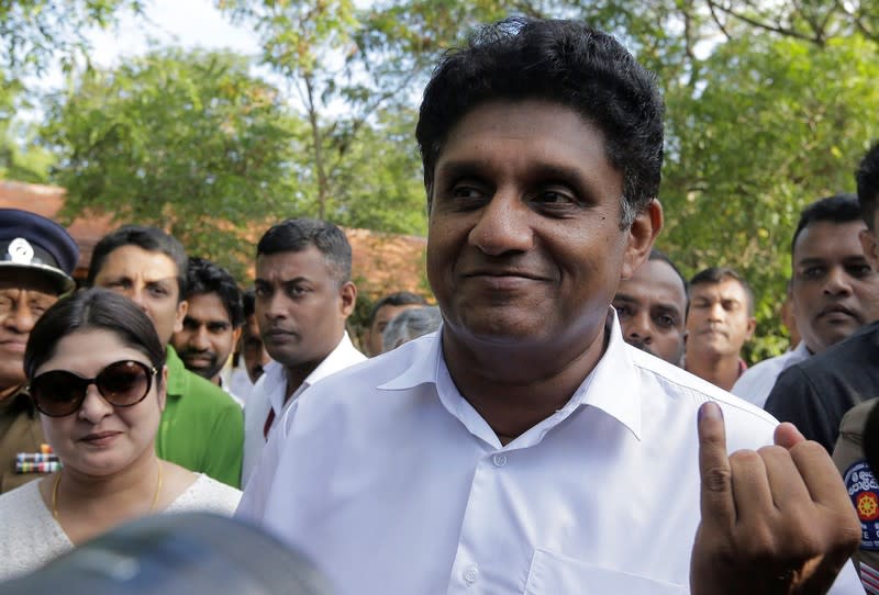 Premadasa, Sri Lanka's presidential candidate of the ruling United National Party led New Democratic Front alliance shows his inked finger after casting his vote during the presidential election in Weerawila