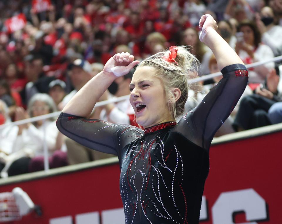 Utah Red Rocks gymnast Lucy Stanhope celebrates her beam routine in Salt Lake City on Friday, Jan. 6, 2023.