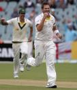 Australia's Ryan Harris (R) celebrates after taking the wicket of England's Graeme Swann (not pictured) during the fifth day's play in the second Ashes cricket test at the Adelaide Oval December 9, 2013. REUTERS/David Gray (AUSTRALIA - Tags: SPORT CRICKET)
