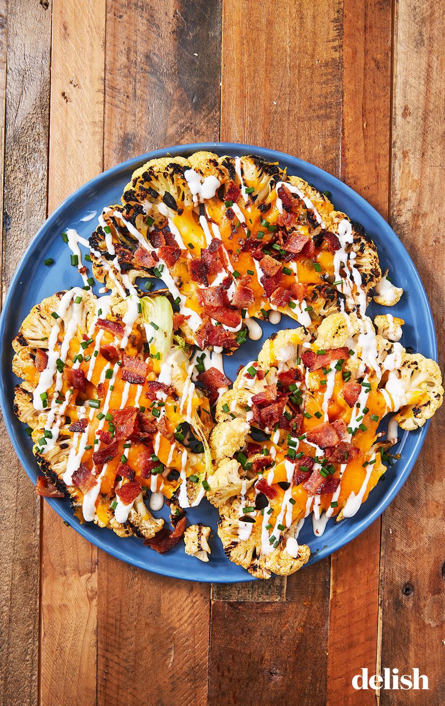 <p>If you're vegetarian, skip the bacon! The charred "steaks" are just as delicious with just the cheese and ranch. </p><p>Get the recipe from <a href="https://edit-delish.hearstapps.com/cooking/recipe-ideas/recipes/a54879/loaded-grilled-cauliflower-recipe/" rel="nofollow noopener" target="_blank" data-ylk="slk:Delish;elm:context_link;itc:0;sec:content-canvas" class="link ">Delish</a>.</p>