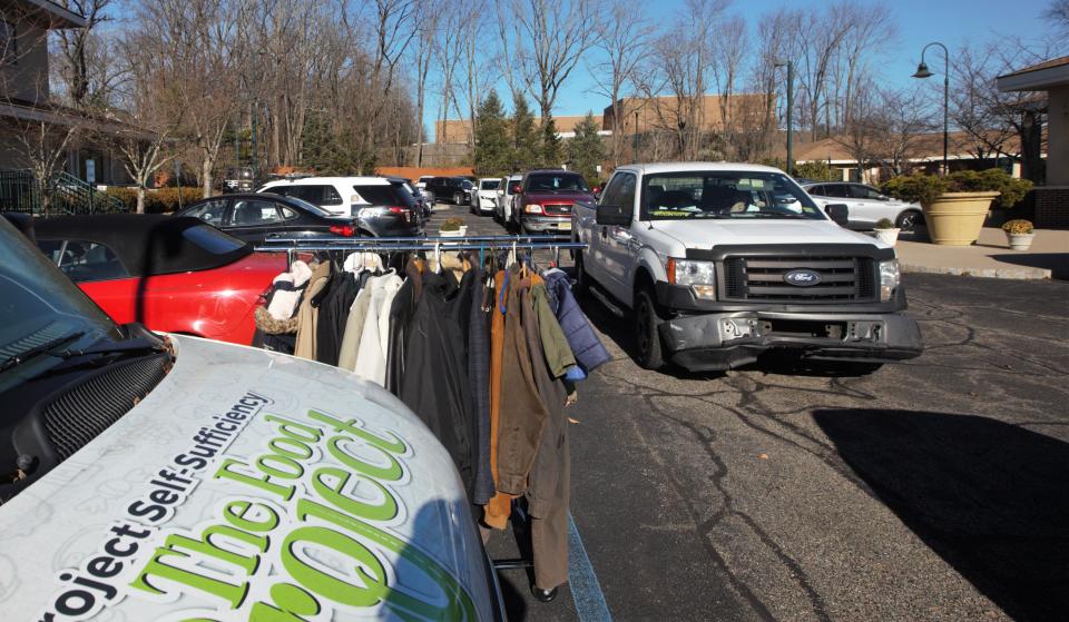 Vehicles lined up to pick up bags filled with a turkey and all the trimmings at Project Self-Sufficiency in Newton on Monday, Nov. 21, 2022. The non-profit was host to a drive-through donation for over 500 families thanks with the help of local businesses, churches and volunteers.
