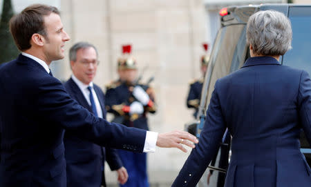 French President Emmanuel Macron and British Prime Minister Theresa May say goodbye as she leaves after a meeting to discuss Brexit, at the Elysee Palace in Paris, France, April 9, 2019. REUTERS/Philippe Wojazer