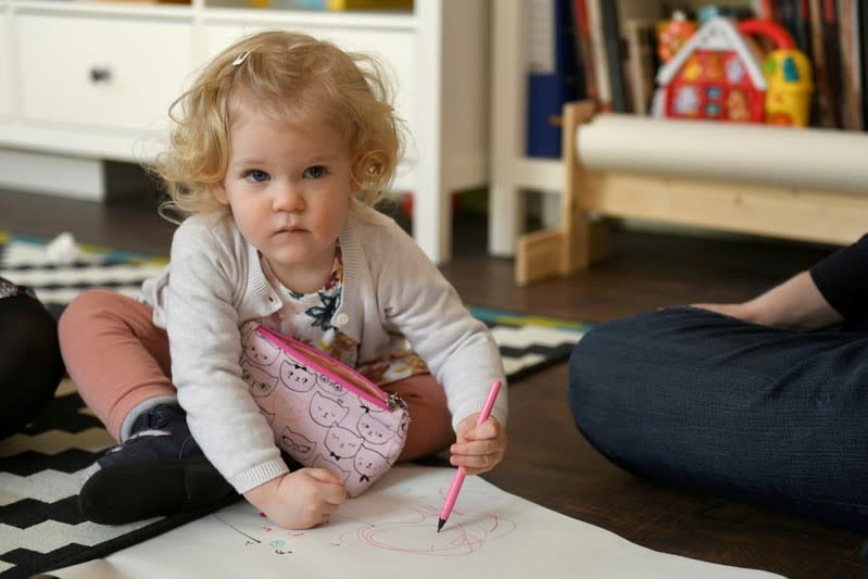 FILE PHOTO: Scharle's daughter plays with her parents in Budakeszi, a western suburb of Budapest