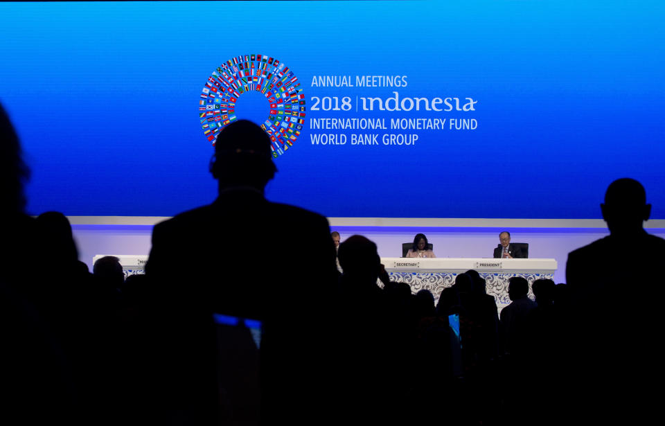 World Bank President Jim Yong Kim, right, attends the opening of International Monetary Fund (IMF) World Bank annual meetings in Bali, Indonesia on Friday, Oct. 12, 2018. (AP Photo/Firdia Lisnawati)