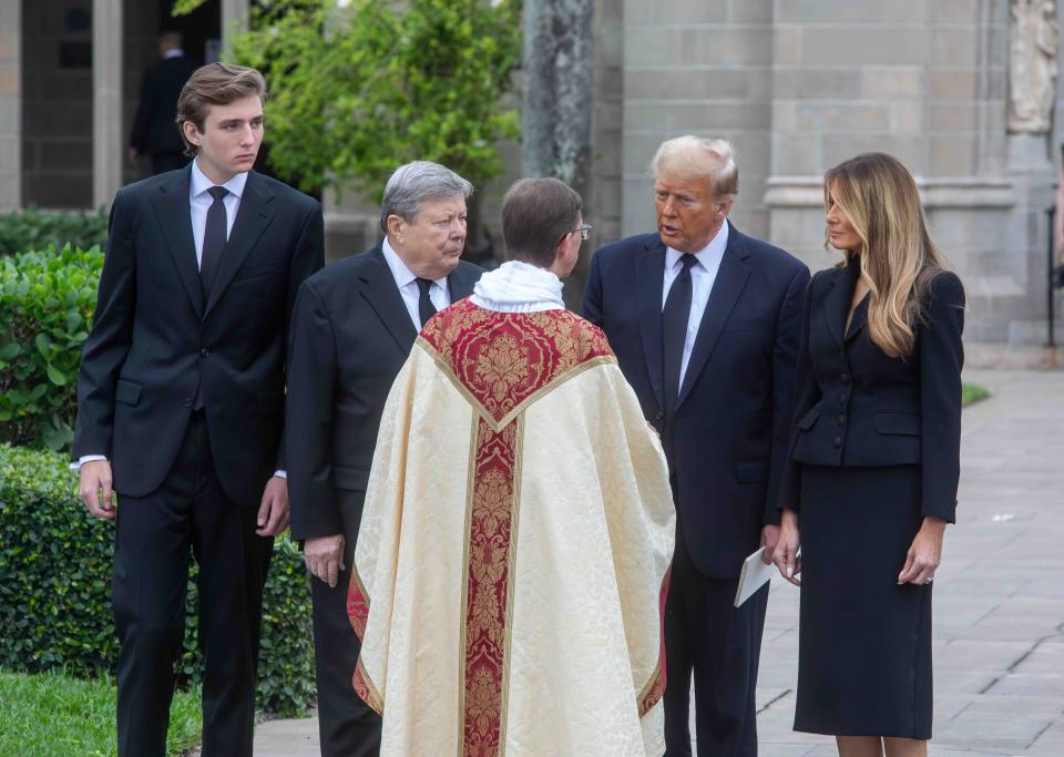 The Rev. Tim Schenck of the Episcopal Church of Bethesda-by-the-Sea speaks briefly with (l-r) Barron Trump, Viktor Knavs, former President Donald Trump, and Melania Trump, following the funeral for Melania's mother, Amalia Knavs, in January.