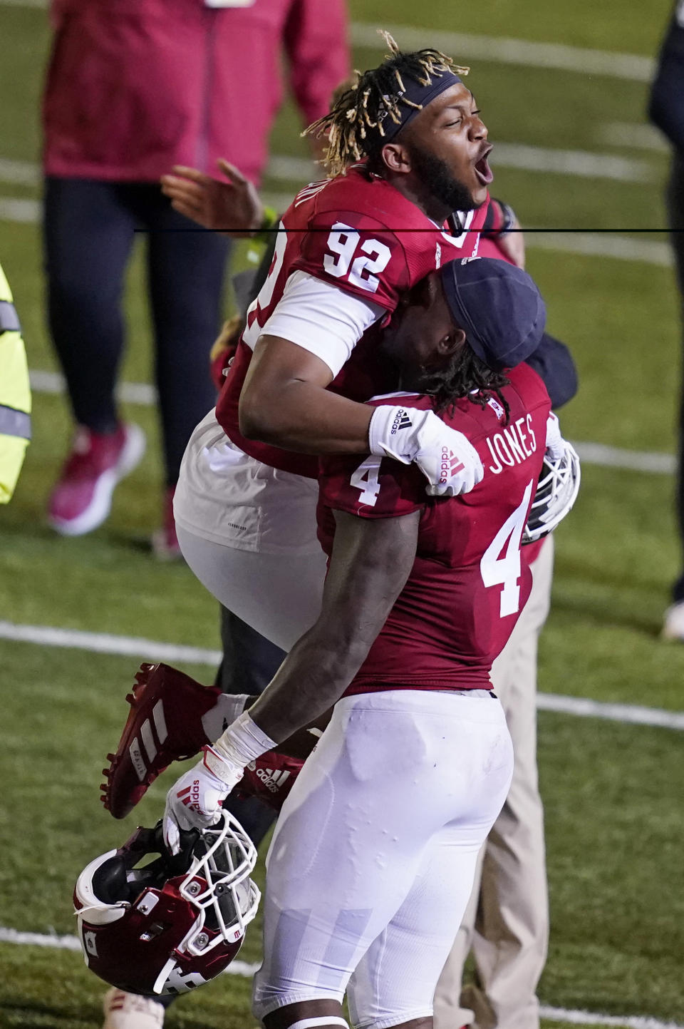 Indiana's Alfred Bryant (92) and Cam Jones celebrate after Indiana defeated Penn State in overtime of an NCAA college football game, Saturday, Oct. 24, 2020, in Bloomington, Ind. Indiana won 36-35 in overtime. (AP Photo/Darron Cummings)