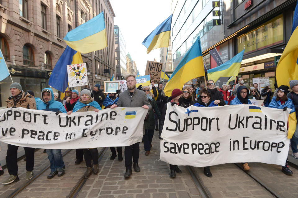 Protestors show their support for Ukraine as they take part in a demonstration against Russia's invasion of Ukraine, in Helsinki on March 5, 2022.<span class="copyright">Mikko Stig—Lehtikuva/AFP/Getty Images</span>