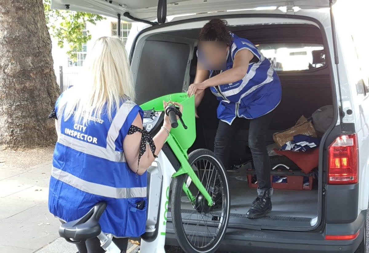 Council workers seize a dockless e-bike (Westminster Council)