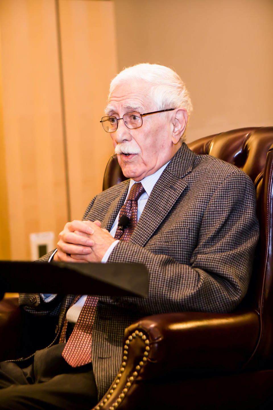 In this photo provided by Stanford Iranian Studies Program, Iranian author Iraj Pezeshkzad speaks at an event for Stanford University's Iranian Studies Program while receiving the Seventh Annual Bita Prize for Persian Arts in Stanford, California, on Nov. 7, 2014. Pezeshkzad, an Iranian author whose bestselling comic novel, "My Uncle Napoleon," lampooned Persian culture's self-aggrandizing and paranoid behavior as the country entered the modern era, died Wednesday, Jan. 12, 2021. He was 94. (Roozbeh Jafarzadeh/Stanford Iranian Studies Program via AP)