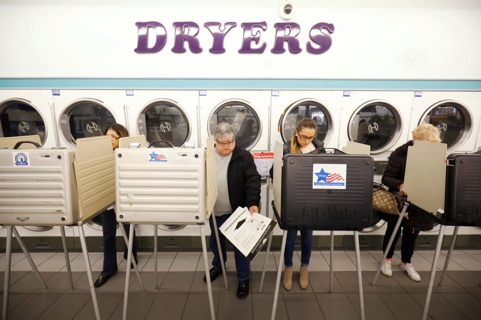 Voter Rojeli Flores casts his ballot in the midterm election at Sunueva Laundromat in Chicago.