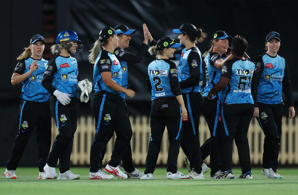 SYDNEY, AUSTRALIA - NOVEMBER 18: Georgia Adams of the Strikers celebrates with teammates after catching out Kate Pelle of the Sixers during the WBBL match between Sydney Sixers and Adelaide Strikers at North Sydney Oval, on November 18, 2023, in Sydney, Australia. (Photo by Mike Owen/Getty Images)