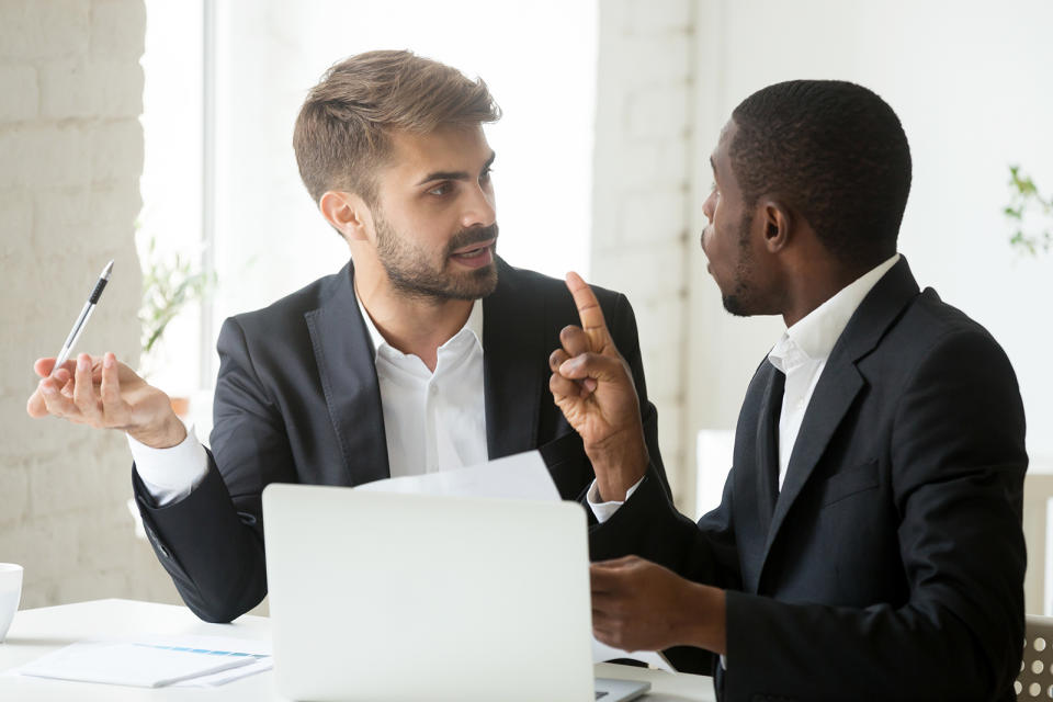 stressed diverse businessmen arguing in office 