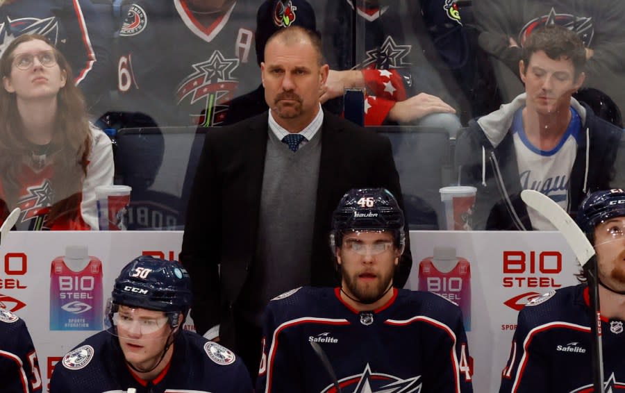 Columbus Blue Jackets coach Brad Larsen, center top, watches his team during the third period of an NHL hockey game against the Ottawa Senators in Columbus, Ohio, Sunday, April 2, 2023. (AP Photo/Paul Vernon)