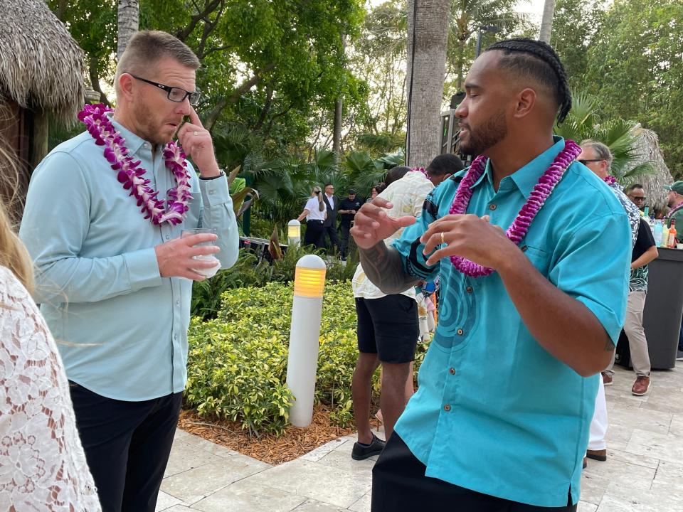 Dolphins quarterback Tua Tagovailoa talks football with a guest at the third annual Luau with Tua on Thursday night at the Seminole Hard Rock Hotel & Casino.