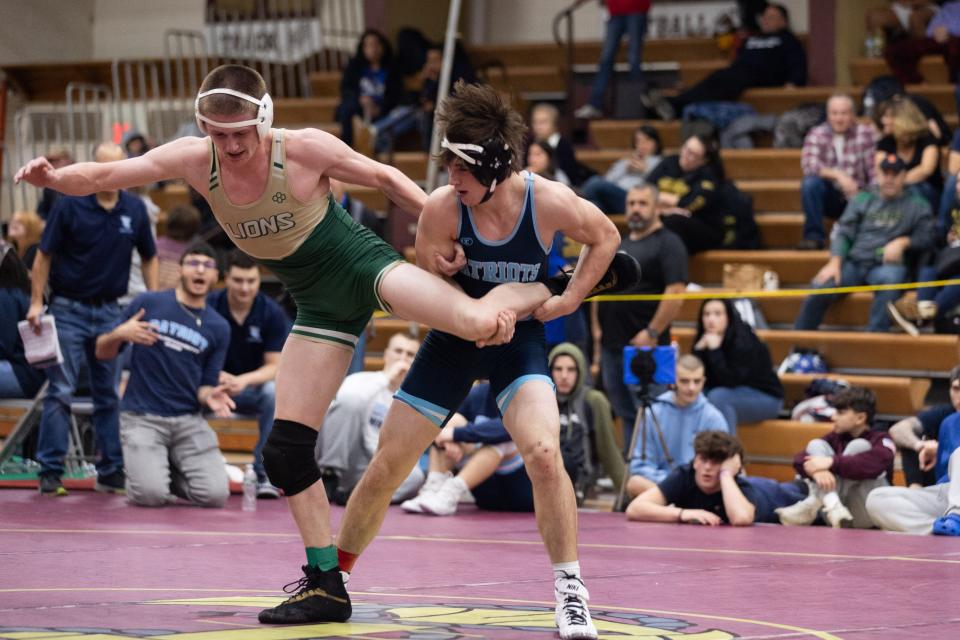 Longwood's Jack Kent, left wrestles John Jay's Brandon DellaPia, right in the 57th Mid-Hudson wrestling Tournament in LaGrange, NY on December 28, 2023.