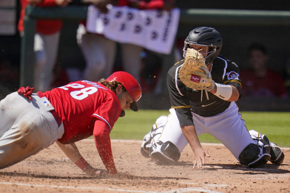 Philadelphia Phillies' Alec Bohm (28) slides safely past a tag-attempt by Pittsburgh Pirates catcher Jacob Stallings to score during the fifth inning of a spring training exhibition baseball game in Bradenton, Fla., Sunday, March 14, 2021. Bohm scored on a single by Matt Joyce. (AP Photo/Gene J. Puskar)