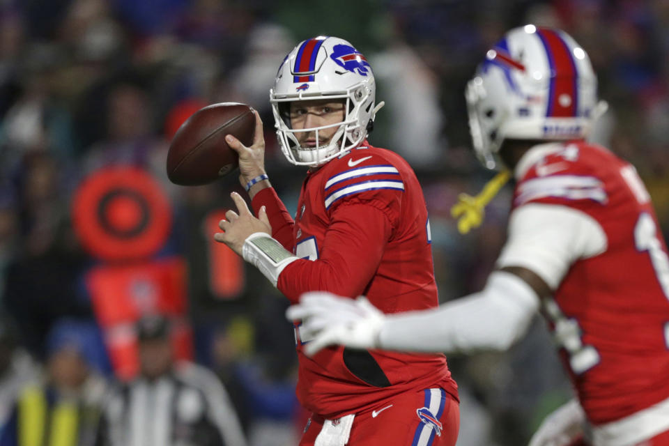 Buffalo Bills quarterback Josh Allen (17) throws a pass to wide receiver Stefon Diggs, right, during the first half of an NFL football game against the Miami Dolphins in Orchard Park, N.Y., Saturday, Dec. 17, 2022. (AP Photo/Joshua Bessex)