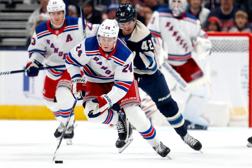 New York Rangers forward Kaapo Kakko, left, chases the puck in front of Columbus Blue Jackets forward Alexandre Texier during an NHL hockey game in Columbus, Ohio, Saturday, Oct. 14, 2023.