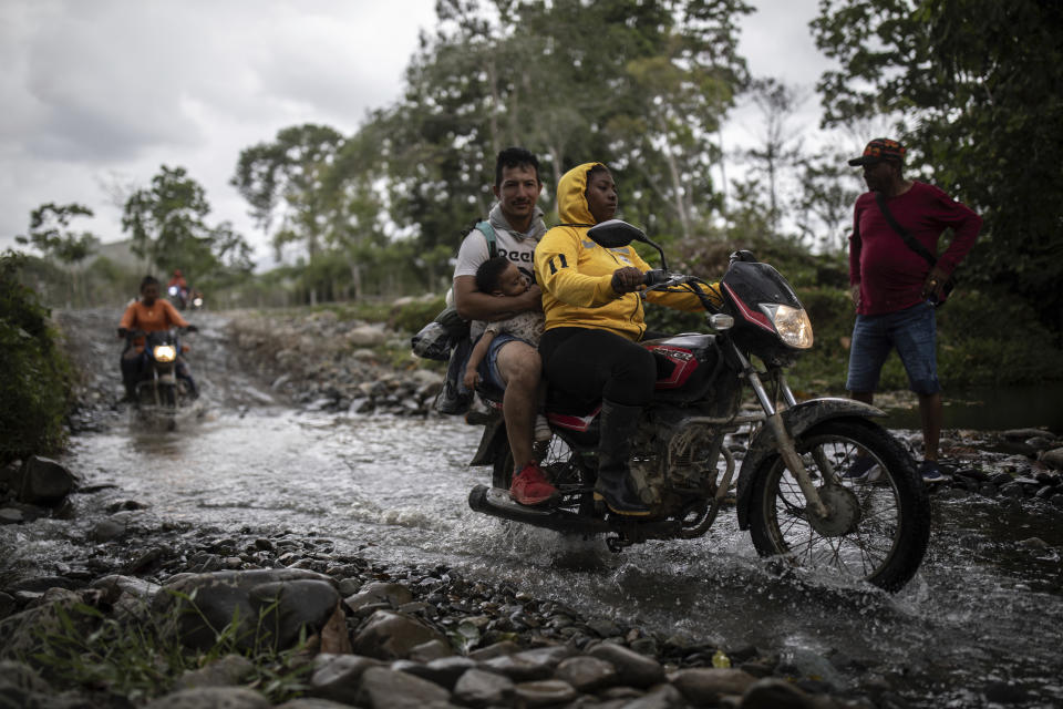 Moto taxis transport migrants to Las Tecas camp from where they will start walking across the Darien gap from Colombia to Panama in hopes of reaching the US, in Acandi, Colombia, Monday, May 8, 2023. (AP Photo/Ivan Valencia)