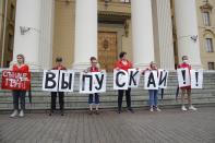 Activists hold posters reading "Release (the arrested people) !!" In front of Belarusian state security service, KGB headquarters in the center in Minsk, Belarus, Wednesday, Aug. 19, 2020. The Belarusian opposition leader has called on European leaders not to recognize "fraudulent elections" that extended the rule of authoritarian President Alexander Lukashenko and sparked unprecedented mass protests in the country. (AP Photo/Dmitri Lovetsky)