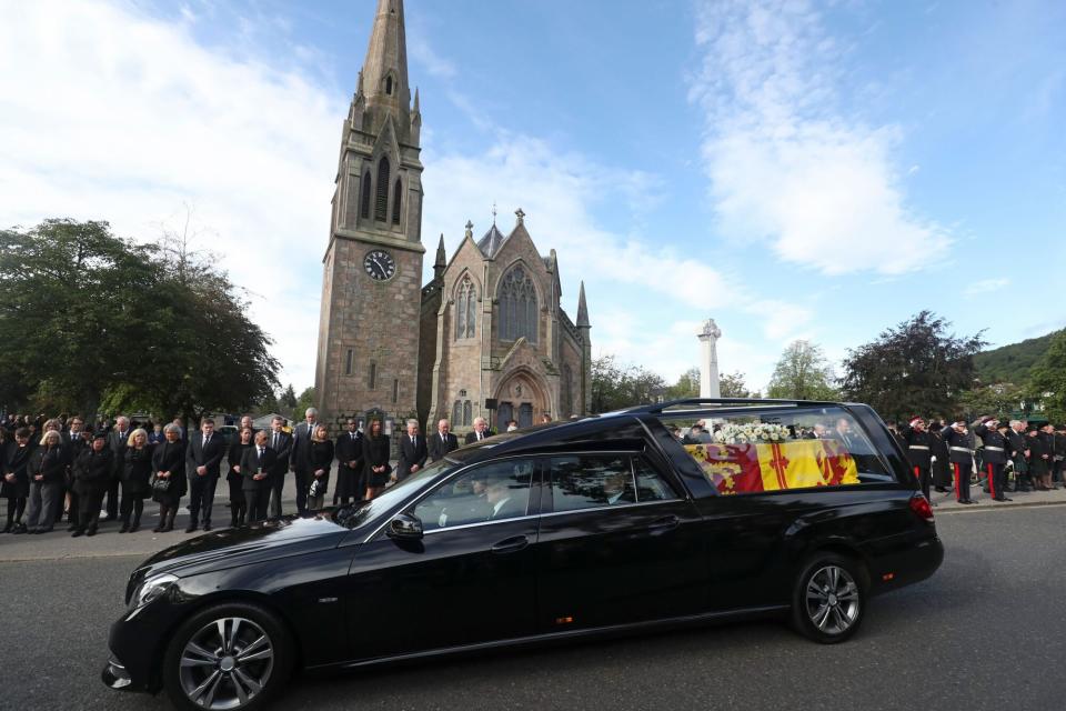 Mandatory Credit: Photo by Scott Heppell/AP/Shutterstock (13382392h) Members of the public line the streets in Ballater, Scotland, as the hearse carrying the coffin of Queen Elizabeth II passes through as it makes its journey to Edinburgh from Balmoral in Scotland, . The Queen's coffin will be transported Sunday on a journey from Balmoral to the Palace of Holyroodhouse in Edinburgh, where it will lie at rest before being moved to London later in the week Royals, Ballater, United Kingdom - 11 Sep 2022