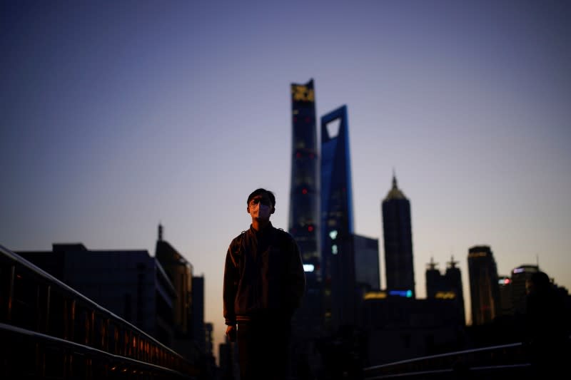 A man wears a protective face mask, following an outbreak of the novel coronavirus disease (COVID-19), at Lujiazui financial district in Shanghai