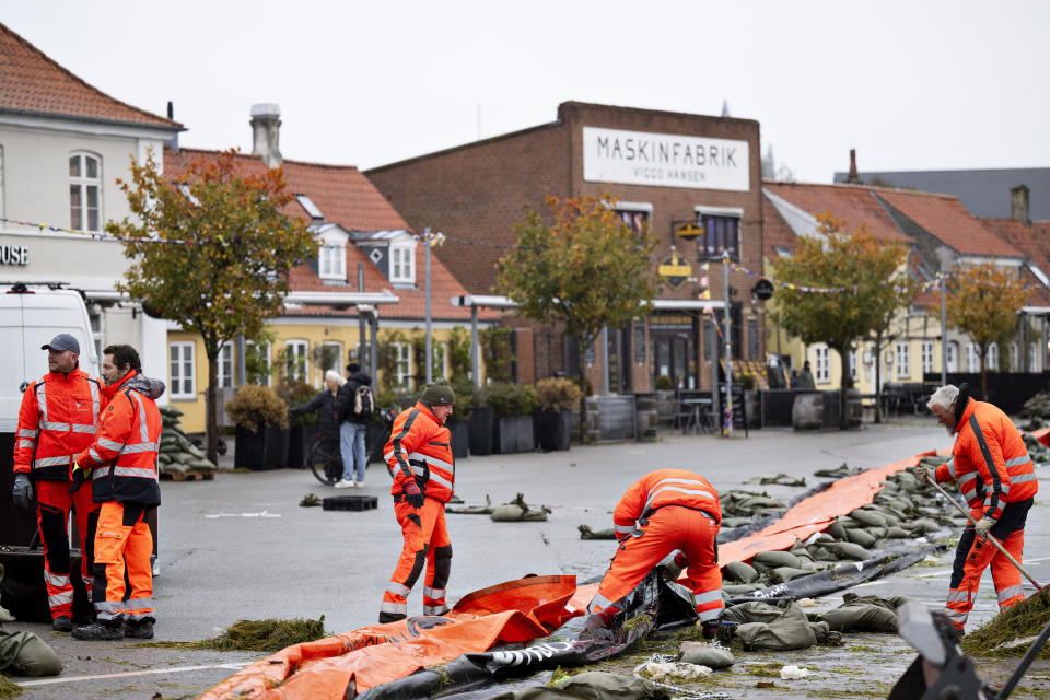 Clean up operation after storm damage in Koege, Denmark, Saturday Oct. 21, 2023. A storm continued to batter Britain, northern Germany and southern Scandinavia early Saturday with powerful winds, heavy rain and storm surges that caused floods, power outages, evacuations, traffic disruptions. (Nils Meilvang/Ritzau Scanpix)