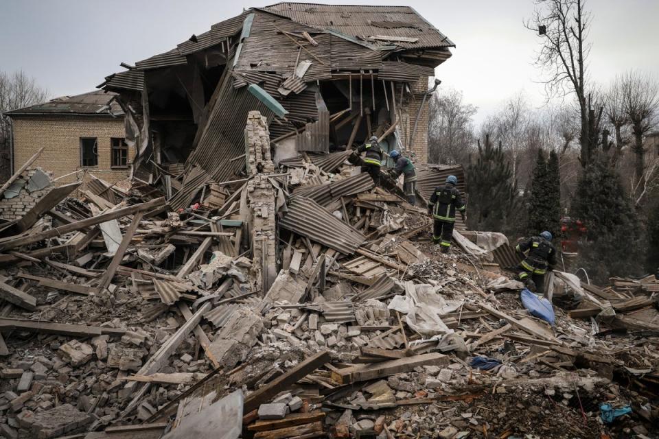 Ukrainian firefighters work at a damaged hospital maternity ward in Vilniansk, in the Zaporizhzhia region (AP)