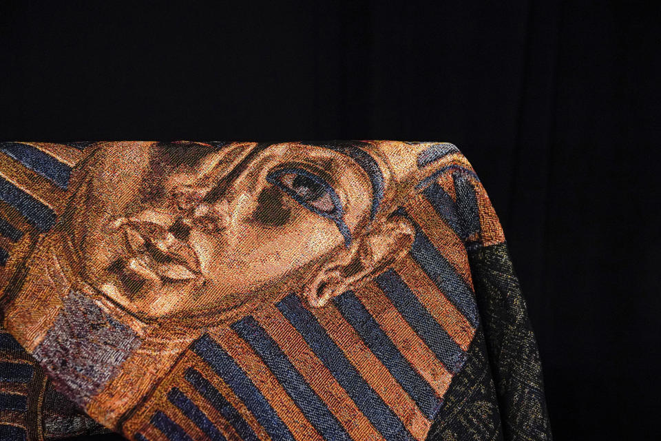 A King Tut tapestry appears at the Beyond King Tut Immersive Experience gift shop, Thursday, Oct. 27, 2022, in New York. The exhibition will open to the public on Friday, in commemoration of the the 100th anniversary of the discovery of King Tut's tomb on Nov. 4, 1922. (AP Photo/Julia Nikhinson)