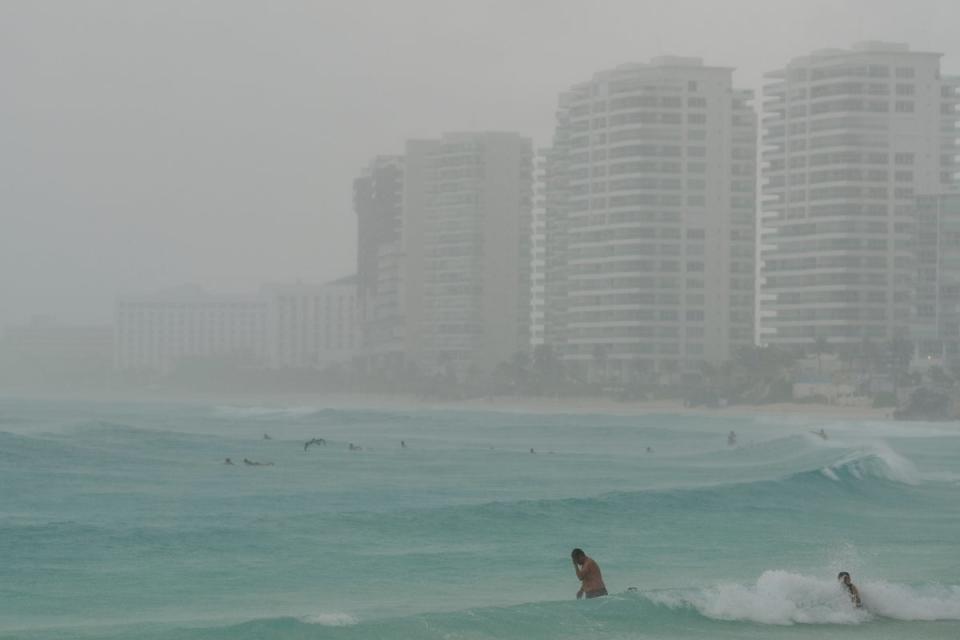 <p>Tourists bathe at a beach as Tropical Storm Helene approaches the Yucatan Peninsula, in Cancun, Mexico</p> (REUTERS)