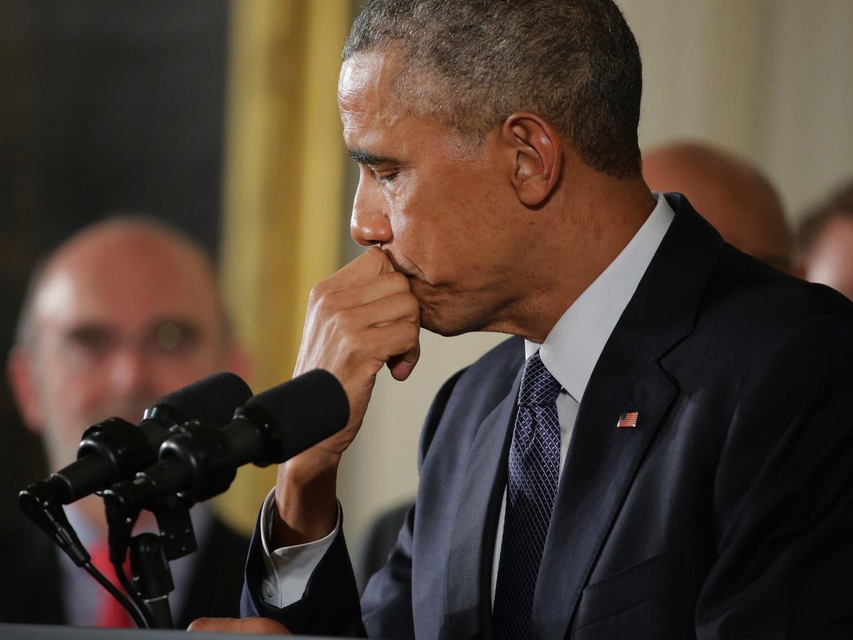 U.S. President Barack Obama pauses as he talks about the victims of the 2012 Sandy Hook Elementary School shooting and about his efforts to increase federal gun control in the East Room of the White House January 5, 2016 in Washington, DC.