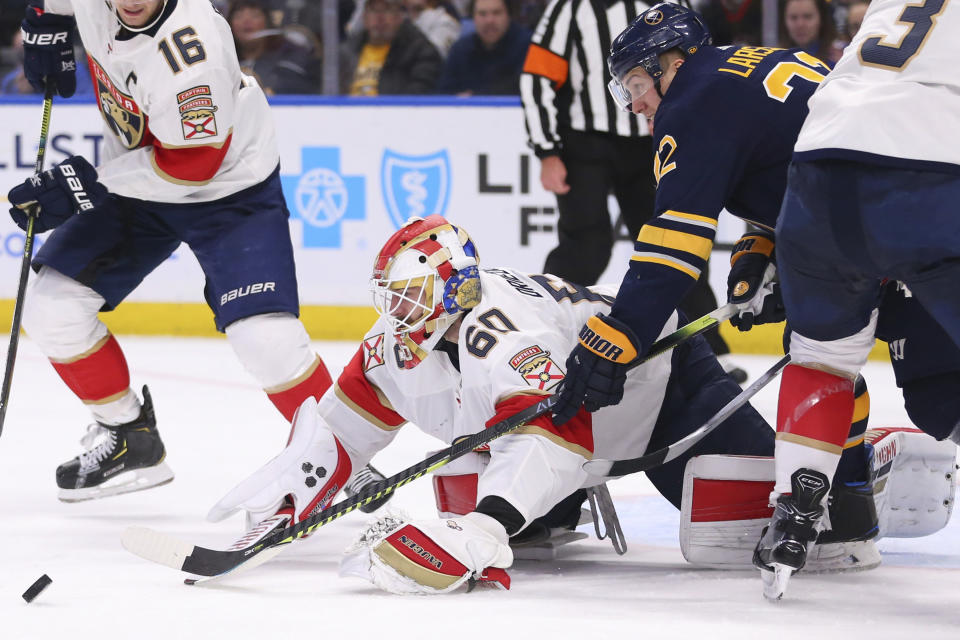 Buffalo Sabres forward Johan Larsson (22) is stopped by Florida Panthers goalie Chris Driedger (60) during the third period of an NHL hockey game Saturday, Jan. 4, 2020, in Buffalo, N.Y. (AP Photo/Jeffrey T. Barnes)