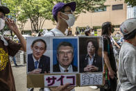 <p>An anti-Olympics protester demonstrates during the Olympic Torch Relay Celebration event on July 23, 2021 in Tokyo, Japan. Protesters gathered to demonstrate against the Olympic Games amid concern over the safety of holding the event during the global coronavirus pandemic as well as the cost incurred. (Photo by Yuichi Yamazaki/Getty Images)</p> 