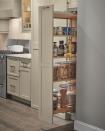 <p>No room for a full-size pantry? This slim pull-out pantry setup from <a href="https://www.diamondcabinets.com/products/organization/tall-pantry-pullout-cabinet/" rel="nofollow noopener" target="_blank" data-ylk="slk:Diamond Cabinets" class="link ">Diamond Cabinets</a> keeps your cooking staples — oils, spices nuts and more – within reach. </p>