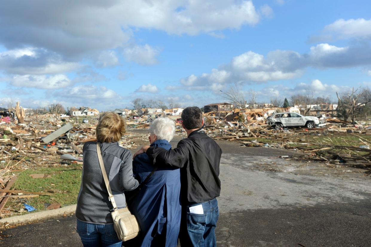 Residents look over their devastated subdivision after a tornado in Washington Sunday, Nov. 17, 2013.