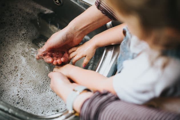 Something as seemingly harmless as washing the dishes could cause raised nail beds and lead to infection. (Photo: Catherine Falls Commercial via Getty Images)