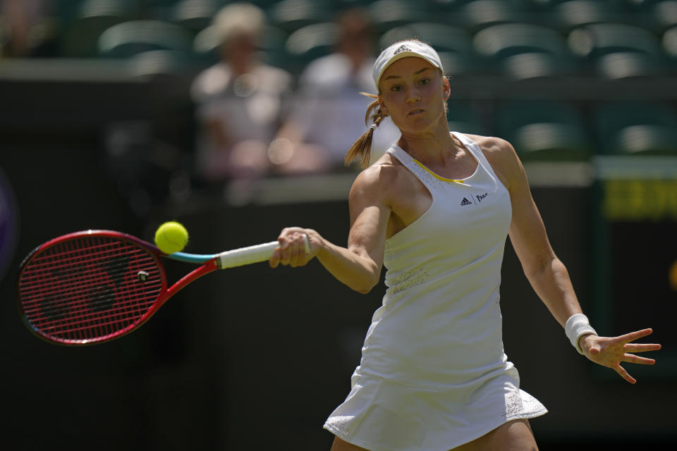 Kazakhstan's Elena Rybakina returns to Croatia's Petra Martic in a women's singles fourth round match on day eight of the Wimbledon tennis championships in London, Monday, July 4, 2022. (AP Photo/Alastair Grant)