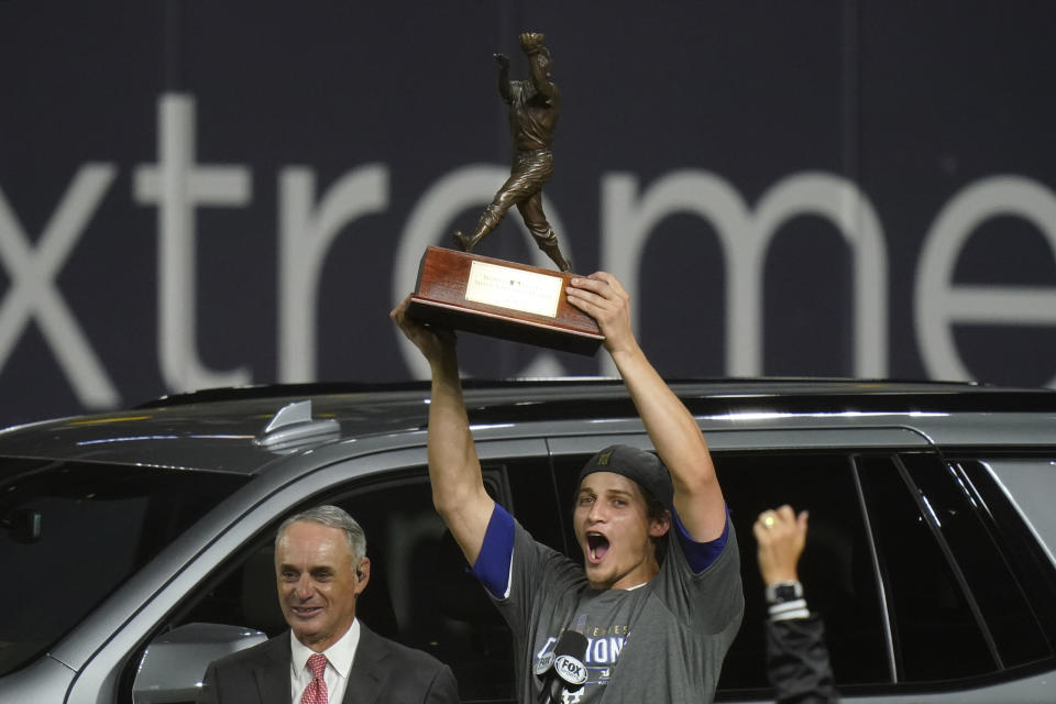 Los Angeles Dodgers shortstop Corey Seager holds up the MVP trophy after defeating the Tampa Bay Rays 3-1 to win the baseball World Series in Game 6 Tuesday, Oct. 27, 2020, in Arlington, Texas. (AP Photo/Eric Gay)