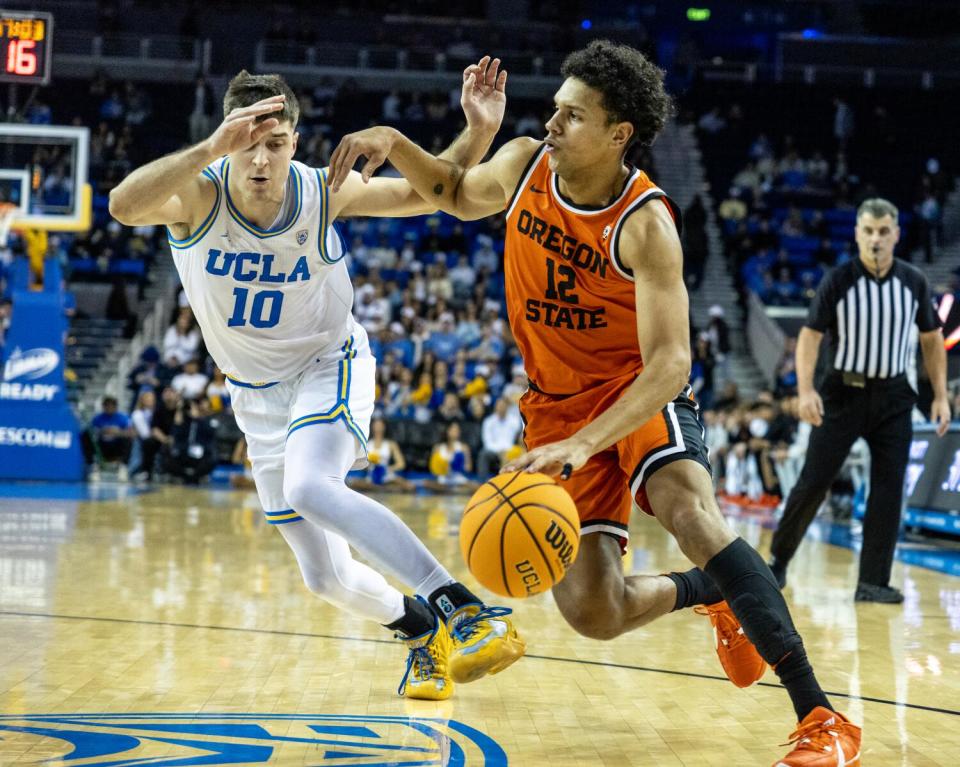 Oregon State forward Michael Rataj, right, tries to drive past UCLA guard Lazar Stefanovic.