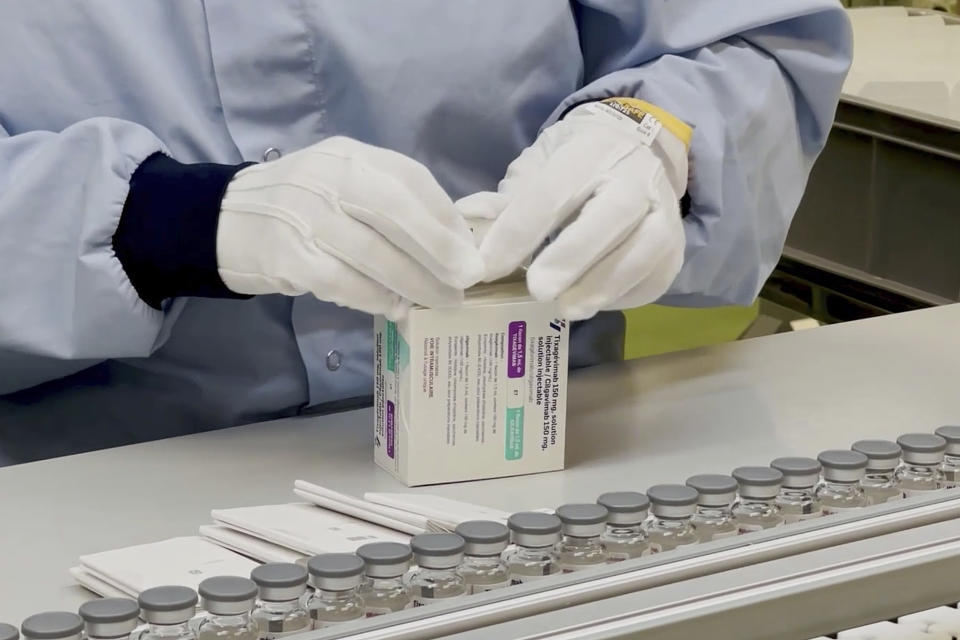 In this image from undated video provided by AstraZeneca in December 2021, a worker packages the company's Evusheld medication. On Wednesday, Dec. 8, 2021, U.S. health officials authorized the new COVID-19 antibody drug for people with serious health problems or allergies who can’t get adequate protection from vaccination. (AstraZeneca via AP)