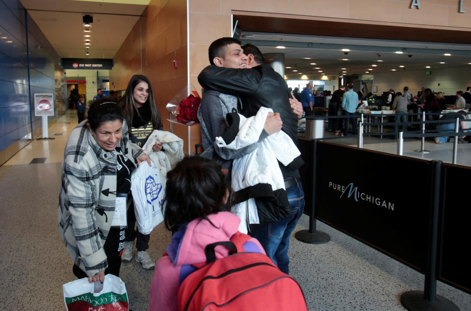 Rami Al-Qassab, at right, hugs his brother after being reunited with his Iraqi refugee mother Amira, left, and siblings after they arrived at Detroit Metro Airport in Romulus, Michigan, Feb. 10, 2017. (Photo: Rebecca Cook / Reuters)