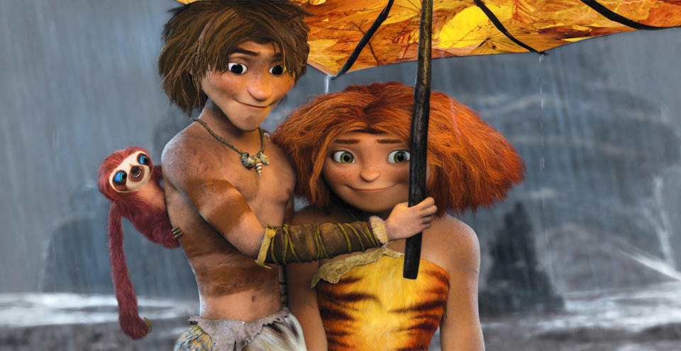 This film publicity image released by DreamWorks Animation shows, from left, Belt the sloth, voiced by Chris Sanders, Guy, voiced by Ryan Reynolds, and Eep, voiced by Emma Stone, in a scene from "The Croods." (AP Photo/DreamWorks Animation)