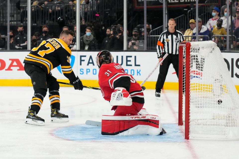 Boston Bruins’ Patrice Bergeron and Carolina Hurricanes goalie Frederik Andersen participate in the Skills Competition save streak event, part of the NHL All-Star weekend, Friday, Feb. 4, 2022, in Las Vegas. (AP Photo/Rick Scuteri)
