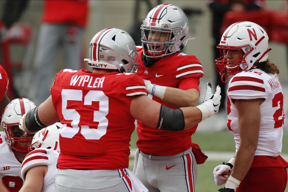 Ohio State quarterback Jack Miller, center, celebrates his touchdown against Nebraska with teammate Luke Wypler during the second half of an NCAA college football game Saturday, Oct. 24, 2020, in Columbus, Ohio. (AP Photo/Jay LaPrete)