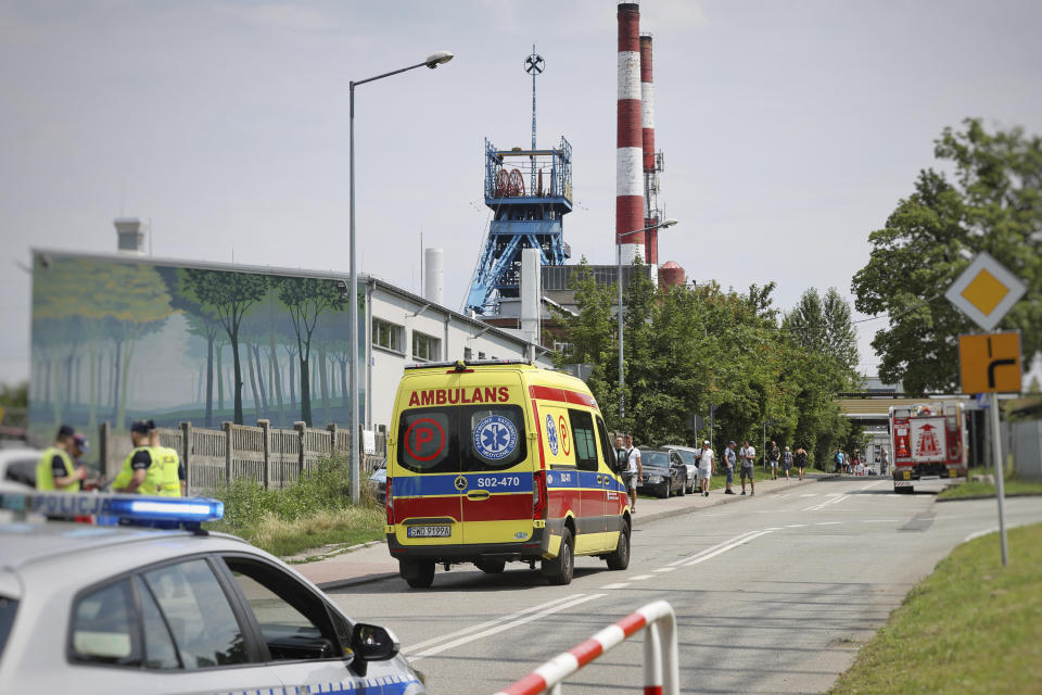 An ambulance heads into the Rydultowy coal mine near the city of Rybnik, in southern Poland, on Thursday, July 11, 2024. Officials say that two Polish coal miners remain unaccounted for and at least 15 have been injured after a powerful tremor shook the Rydultowy coal mine. Rescuers are struggling to reach dozens of others. (AP Photo/Katarzyna Zaremba-Majcher)