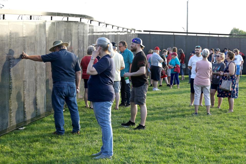 Visitors gather at the "Wall that Heals" replica of the Vietnam Veterans Memorial in Belvidere, Illinois, on May 12. The wall will be in Erie over Memorial Day weekend.