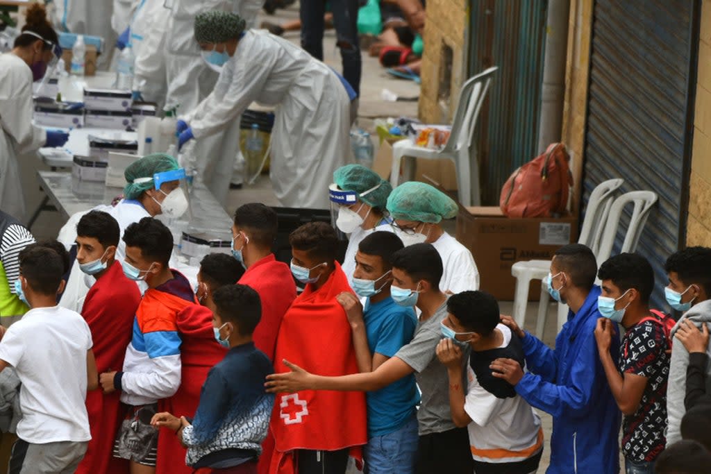 Migrants aged below 18 wait to be tested for Covid-19 upon their arrival in the Spanish enclave of Ceuta in May (AFP/Getty)