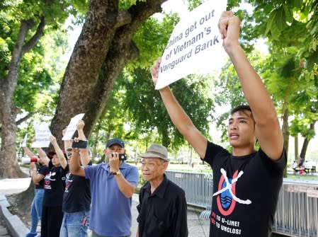 Anti-China protesters hold placards during a demonstration in front of the Chinese embassy in Hanoi