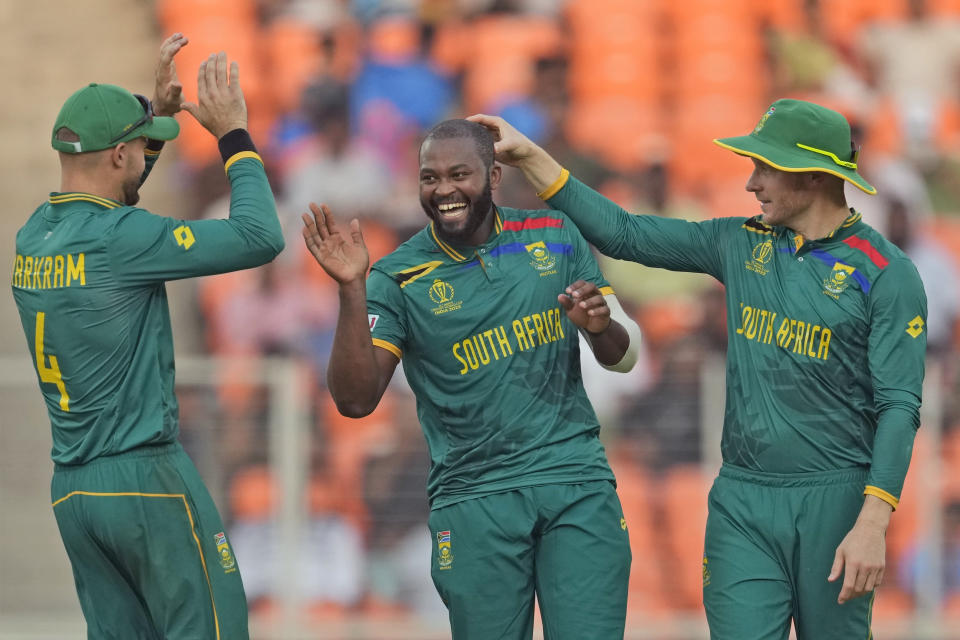 South Africa's Andile Phehlukwayo, center, celebrates with teammates David Miller, right, and Aiden Markram the wicket of Afghanistan's Rashid Khan during the ICC Men's Cricket World Cup match between Afghanistan and South Africa in Ahmedabad, India, Friday, Nov. 10, 2023. (AP Photo/Ajit Solanki)