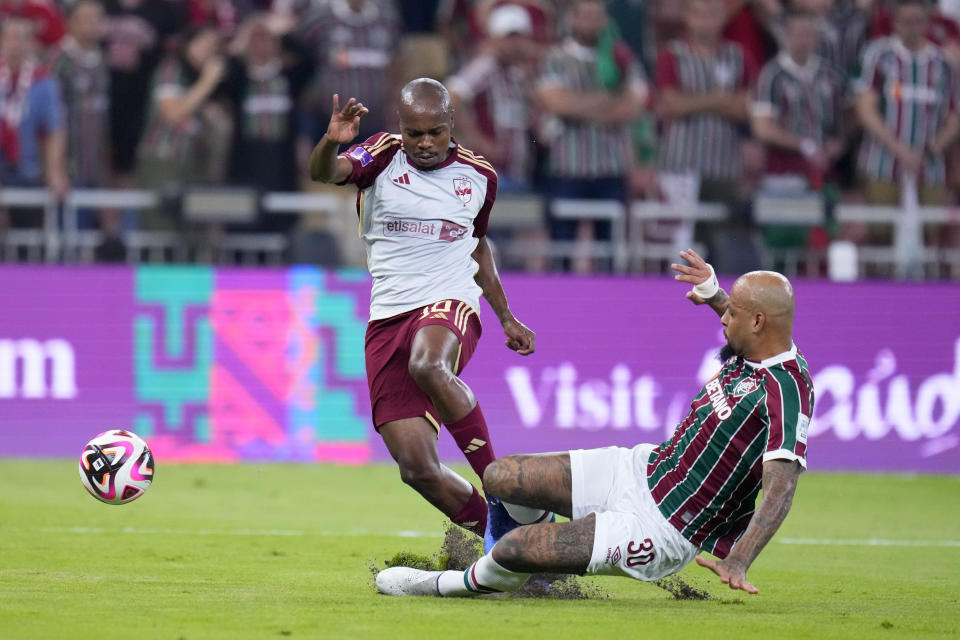 Fluminense's Felipe Melo tries to tackle Al Ahly's Percy Tau, left, during the Soccer Club World Cup semifinal soccer match between Fluminense FC and Al Ahly FC at King Abdullah Sports City Stadium in Jeddah, Saudi Arabia, Monday, Dec. 18, 2023. (AP Photo/Manu Fernandez)